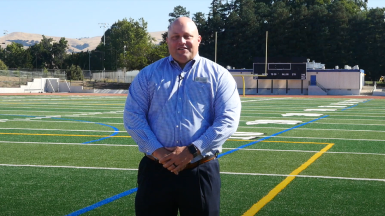 superintendent standing on football field