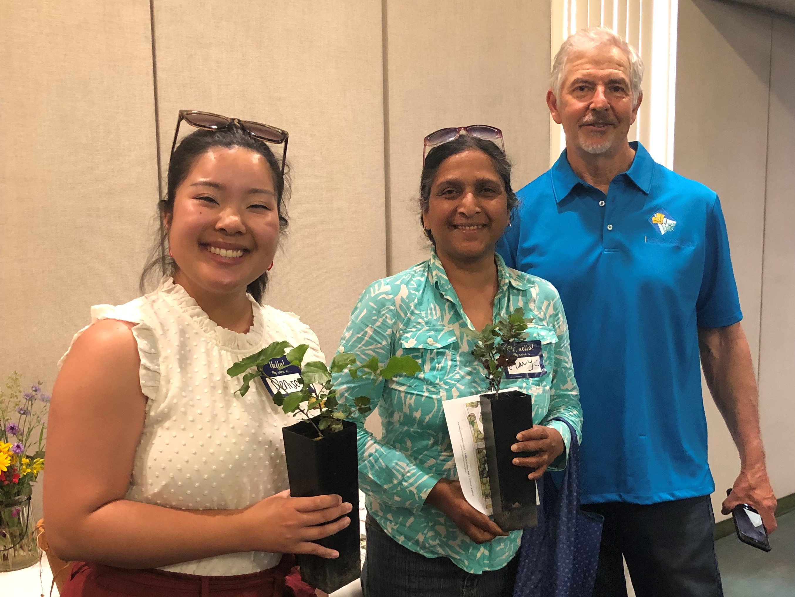 adults holding plants