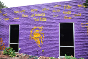 John F. Kennedy purple wall with logo